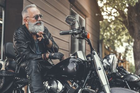 83869640 hilarious smiling old man keeping smoke
