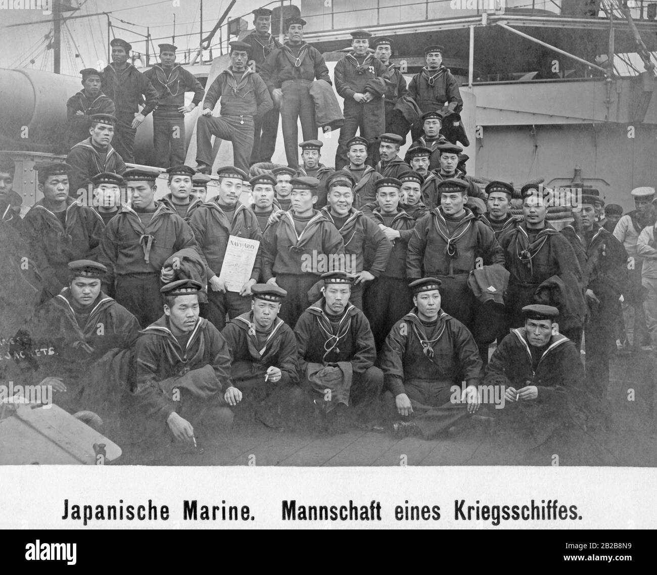 Members of the crew of a japanese warship posing for a group photo on deck of the ship 2B2B8N9