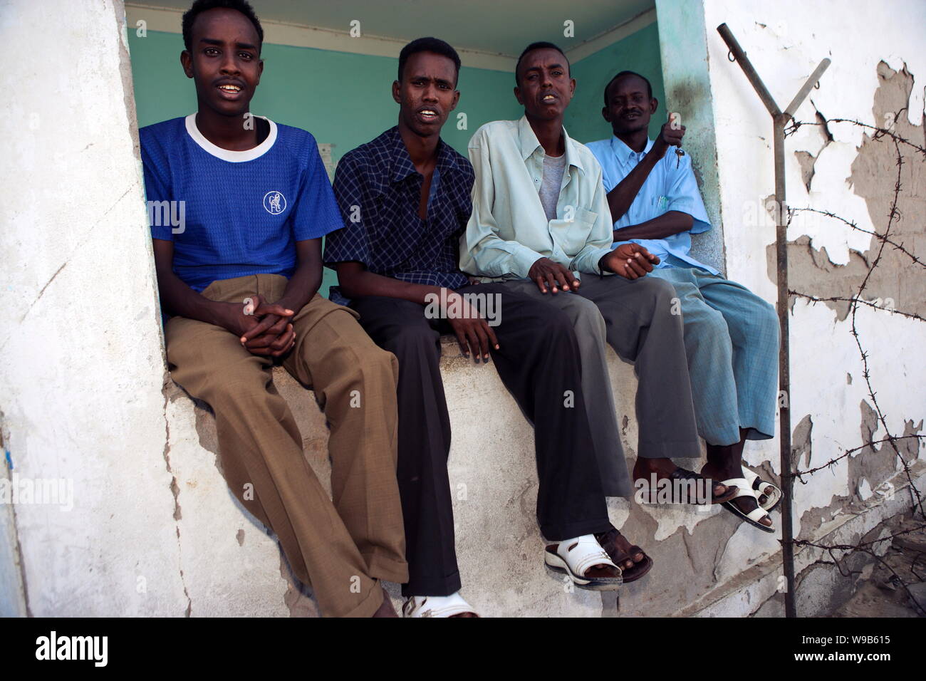 Jobless somali men pose for photos at the harbor in bosaso boosaaso somalia 20 january 2009 tw