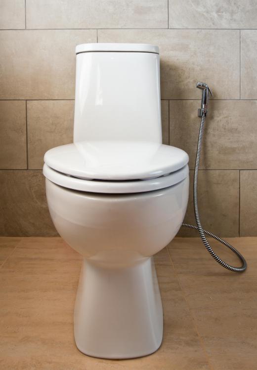 White toilet against stone wall