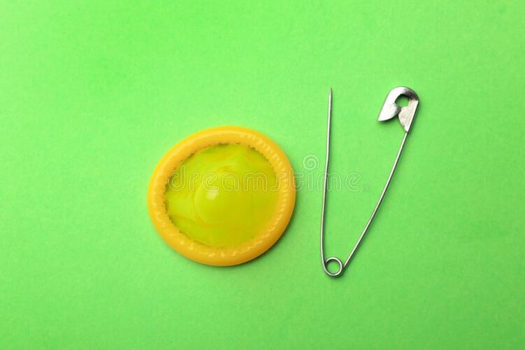 yellow-condom-pin-green-background-flat-lay-yellow-condom-pin-green-background-161050537.jpg