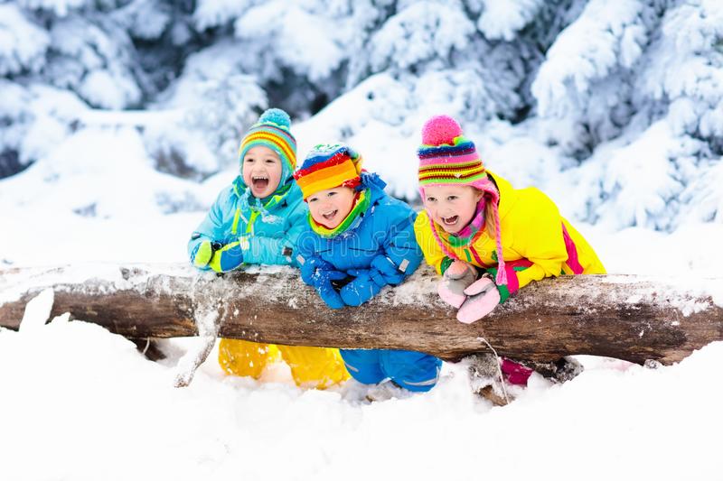 Kids playing snow children play outdoors winter snowfall snowy day boy girl catching snowflake