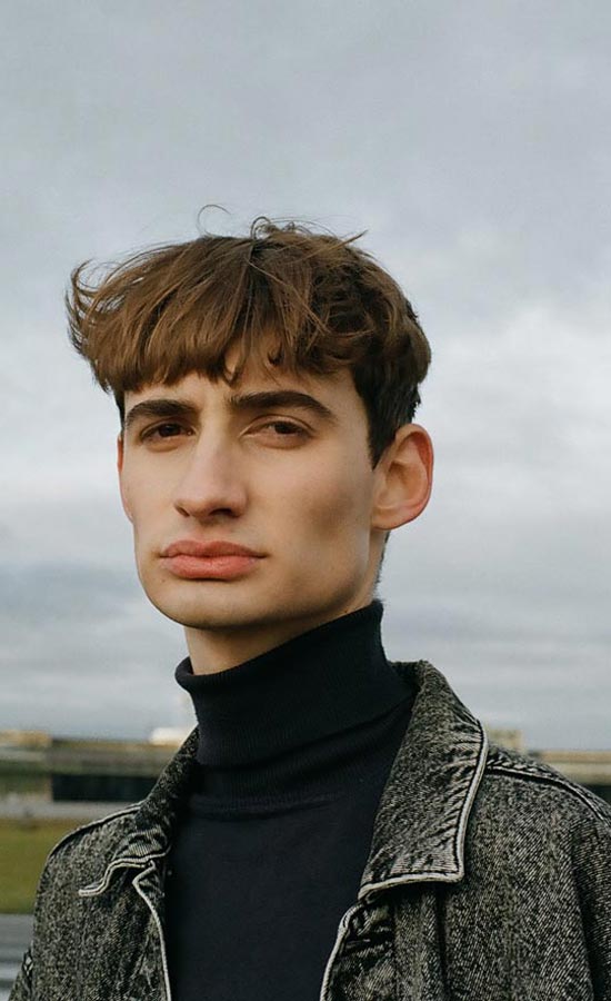 Emanuel cover black turtleneck jeans jacket grey sky male model nature