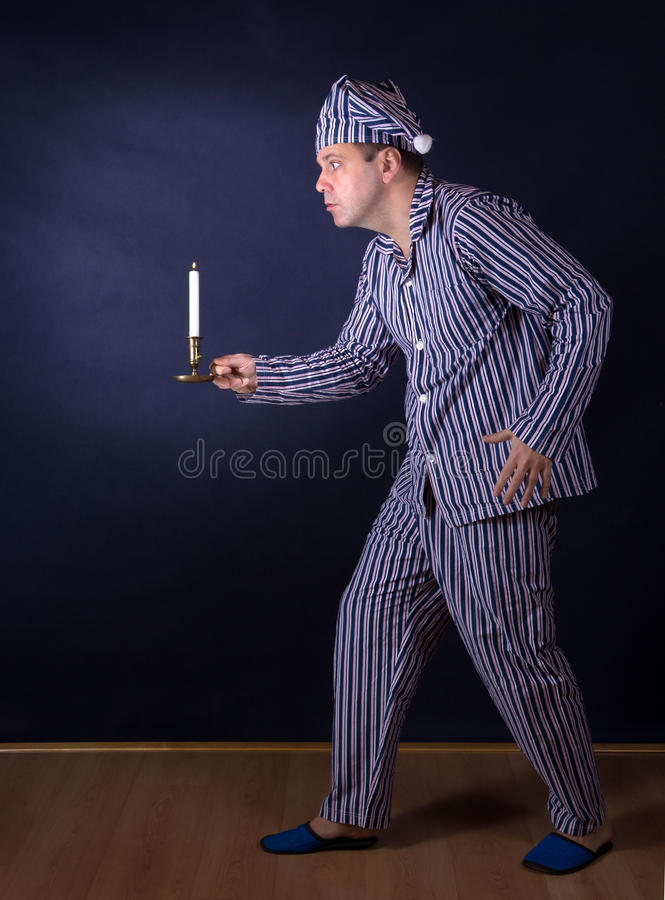 Man candle pajamas frightened 55019617