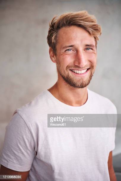 Portrait of happy young man wearing white t shirt