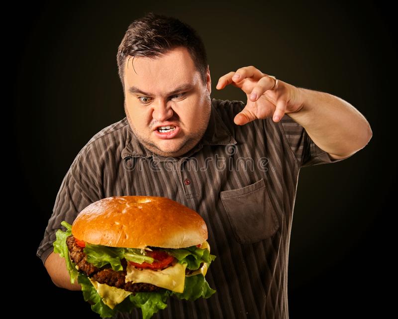 Fat man eating fast food hamberger breakfast overweight person diet failure who huge hamburger