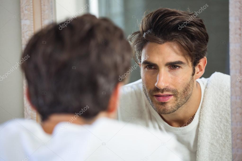 Depositphotos 104783580 stock photo man looking himself in mirror