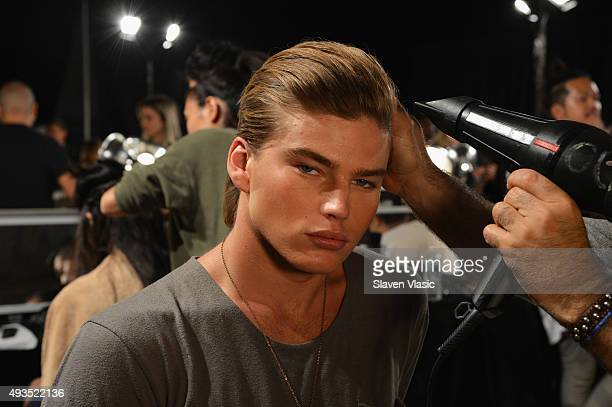 Model jordan barret prepares backstage at the balmain x h m collection launch at 23 wall