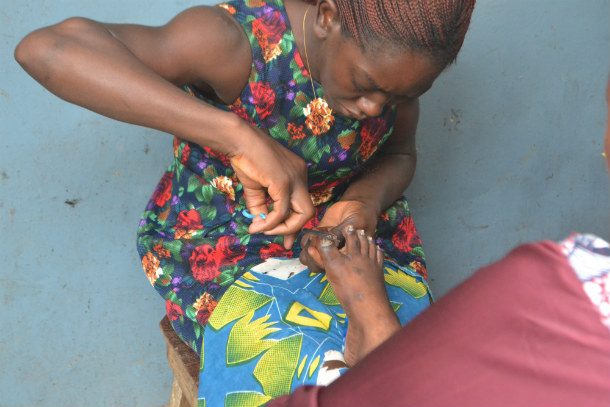 Street esthetician providing toenails care 610x407