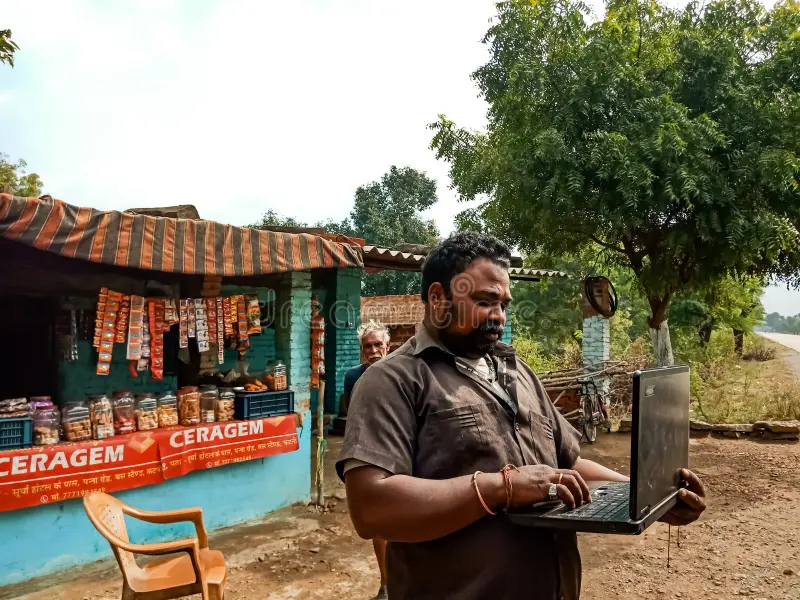 Indian fat man operating laptop front grocery store india january 168316809