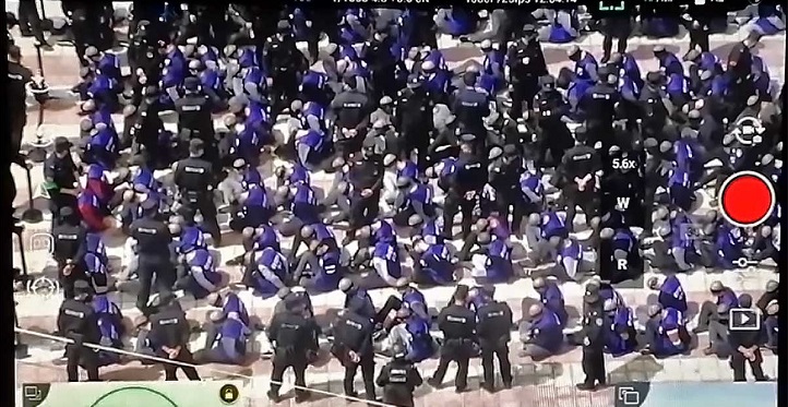 Drone footage shows Chinese police officers moving hundreds of blindfolded and shackled prison