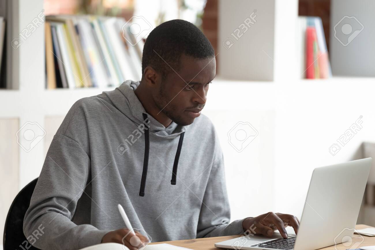 134439505 serious concentrated african american male student using laptop busy with studying p