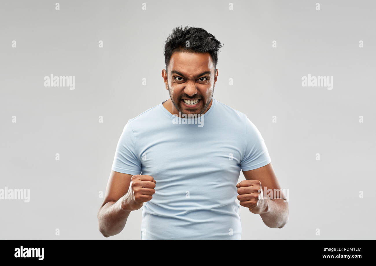 Angry indian man screaming over grey background RDM1EM