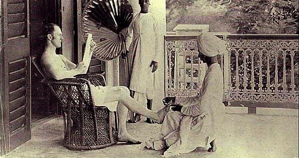 A british man gets a pedicure from an indian servant