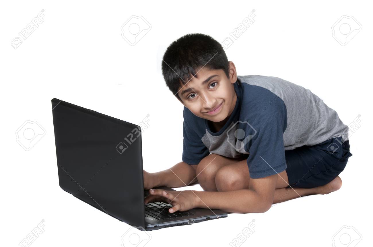 9662841 an handsome indian kid having fun with laptop