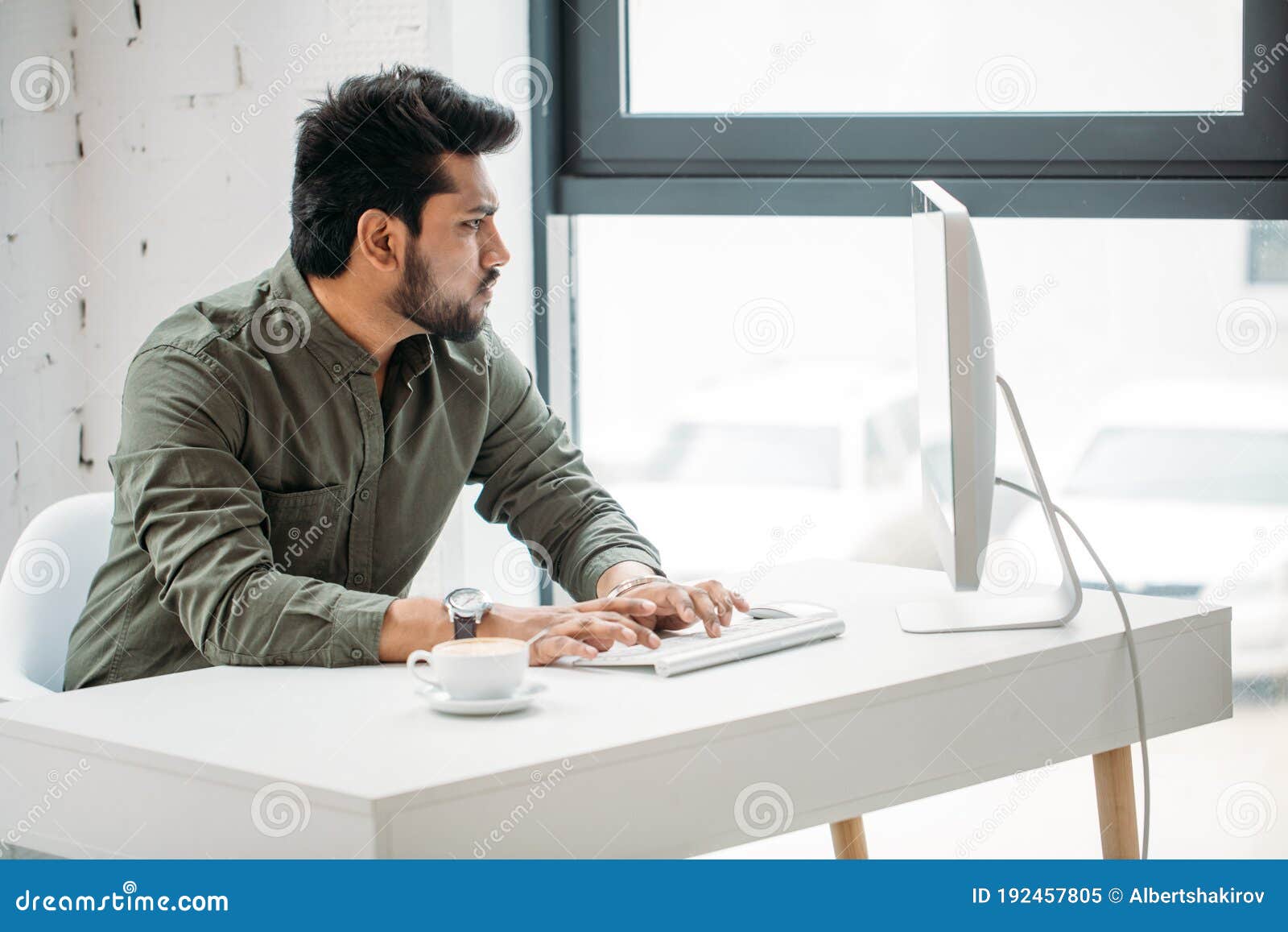 Indian man working computer modern bright office creative pc 192457805