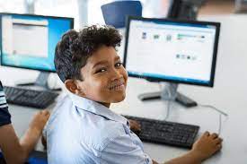 School boy using computer stock image. Image of computer - 115138405