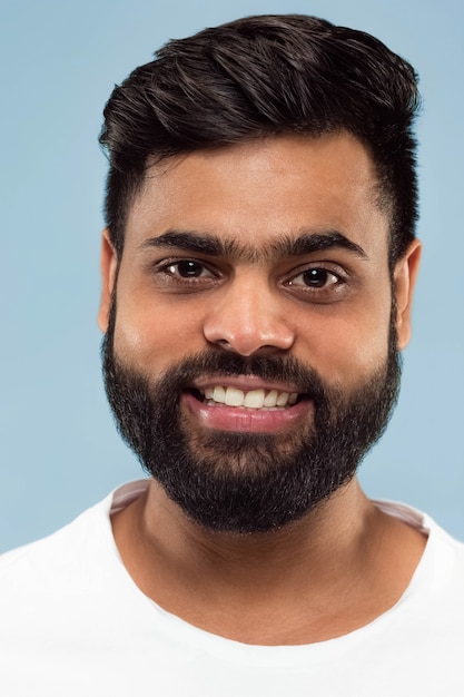 Close up portrait young indian man with beard white shirt isolated standing smiling 155003 23823