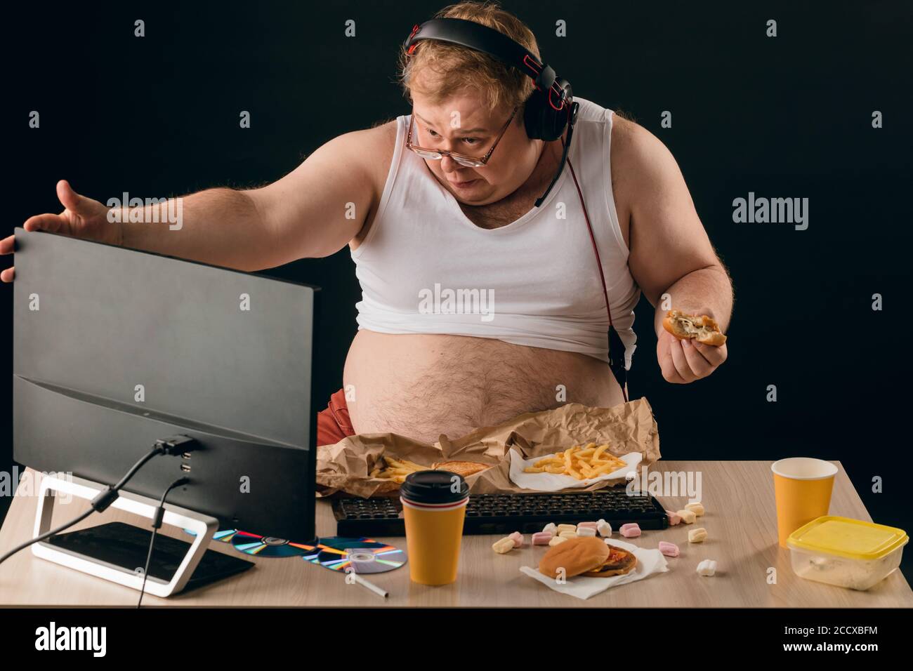 Obese man talking with a computer close up portrait isolated black backgroundlifestyle concept