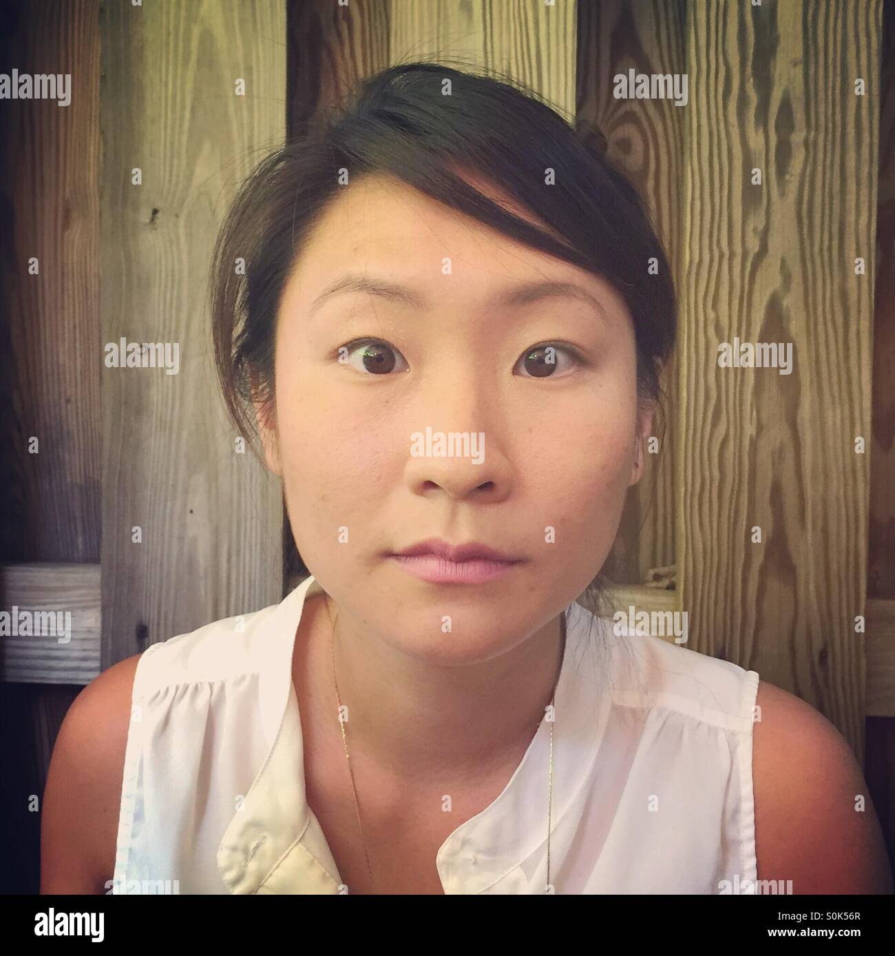 Young asian woman looks startled S0K56R