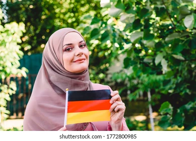 Muslim woman hijab holds flag 260nw 1772800985