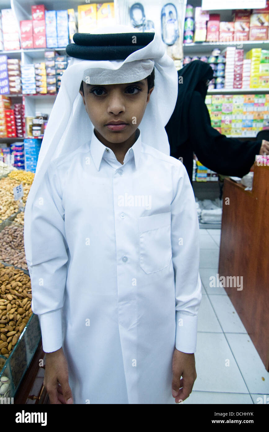 A young qatari boy waring a traditional jalaba and keffiyehkufiya DCHHYK