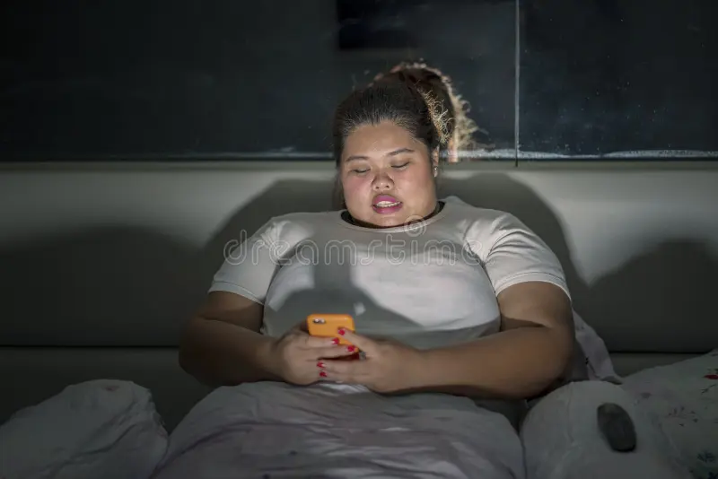 Obese woman using mobile phone sleep picture obese woman using mobile phone sleep night time 