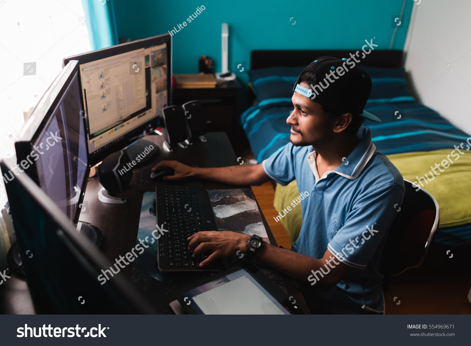 Stock photo young indian guy using computer 554969671