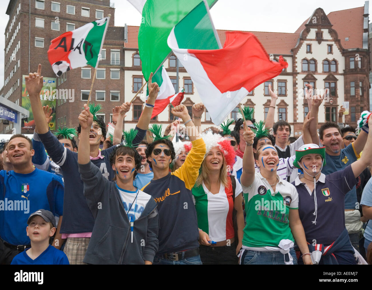 Italian football fans cheering in good mood during the world cup match AEEMJ7