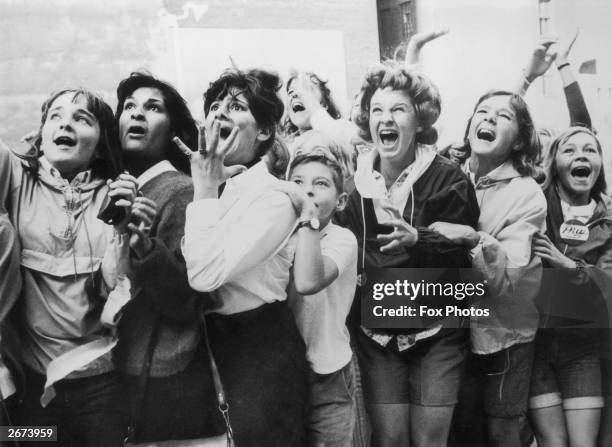 Women and girls in toronto canada screaming with joy during a visit by the beatles to their city