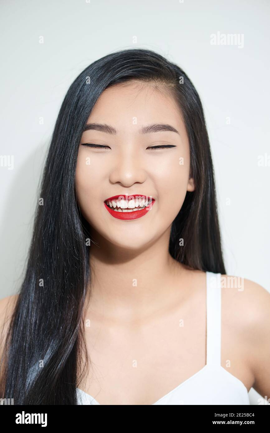 Young beautiful asian woman with smiley face and red lips 2E25BC4