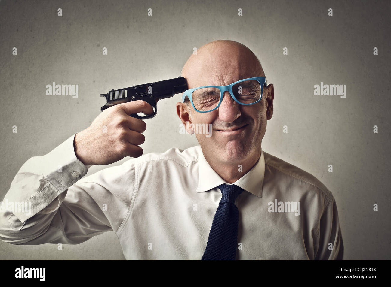 Businessman holding gun to his head J2N3T8