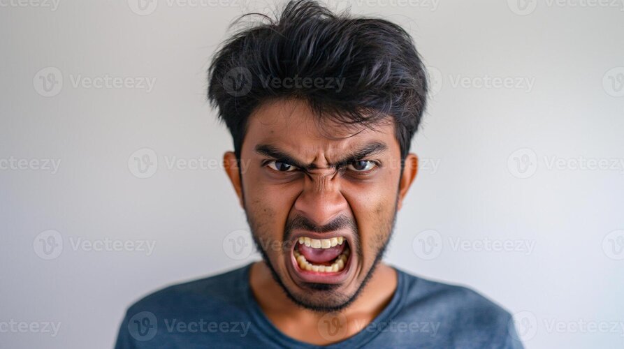 Angry south asian man yelling intense facial expression in indoor setting photo