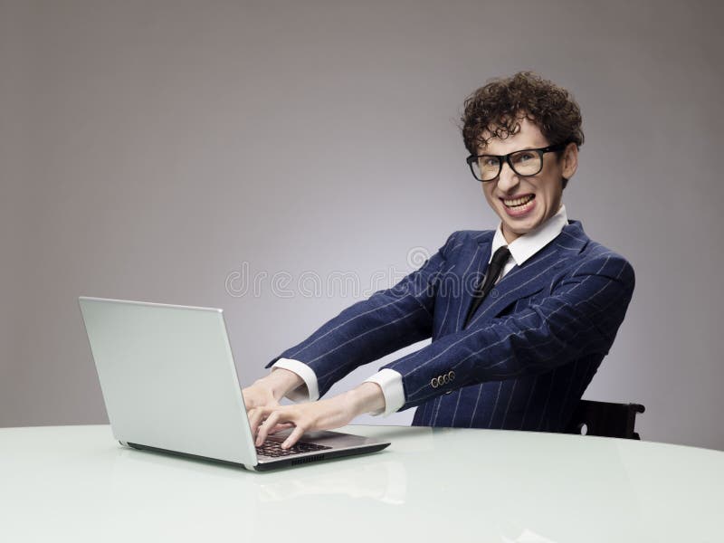 Funny man using laptop business geek evil genius facial expression 92803443