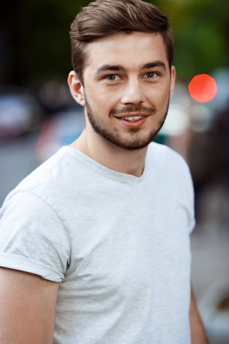 Close up portrait handsome smiling young man white t shirt blurry outdoor nature 176420 6305