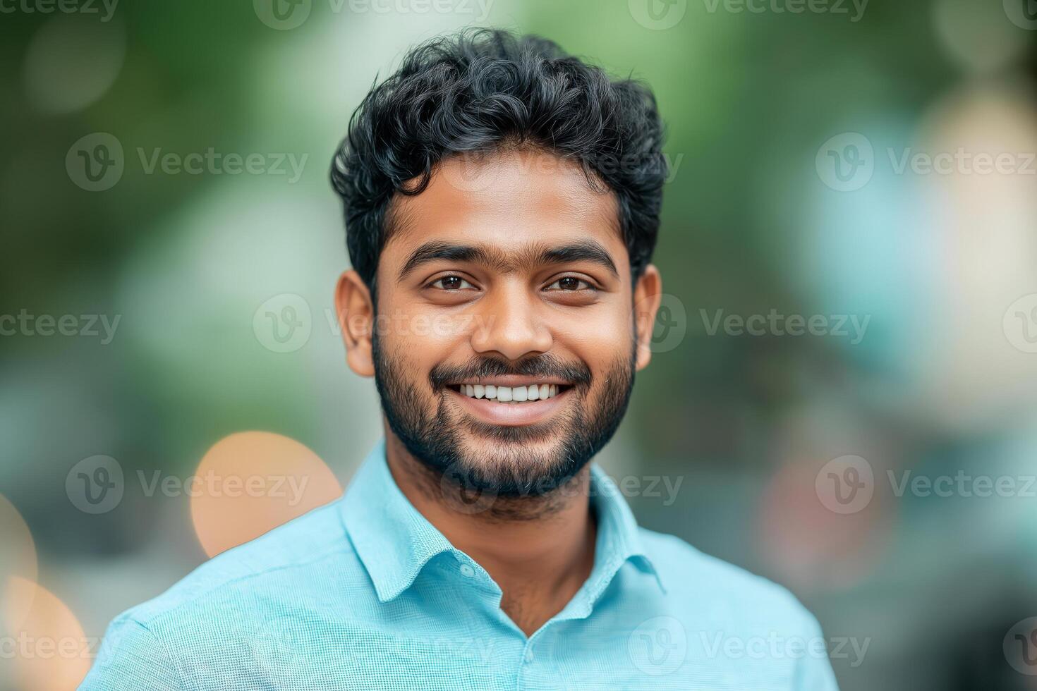 A smiling young indian man with formal shirts outdoors photo