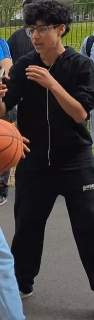 A person in black shirt and black pants holding a basketballAI-generated content may be incorrect.