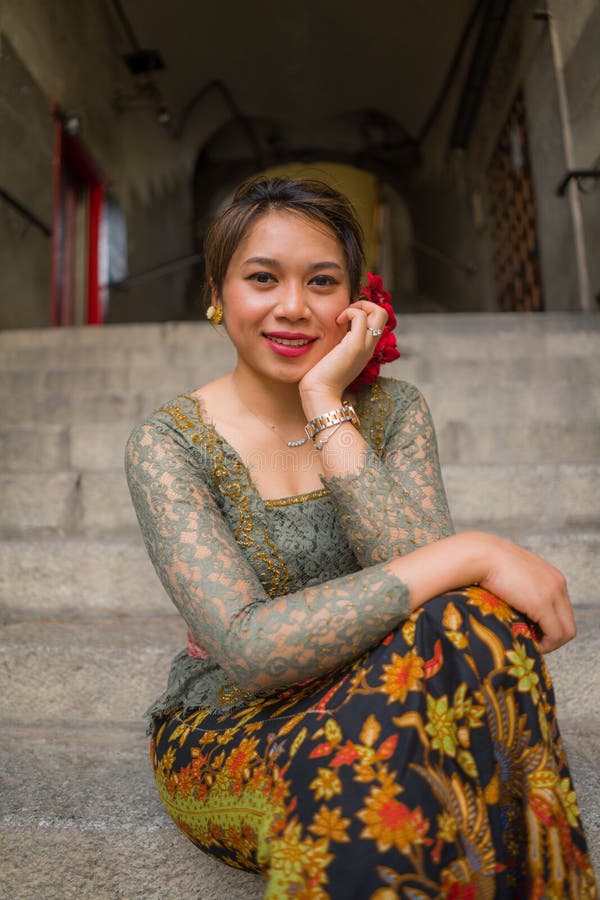 Young happy beautiful asian woman wearing traditional balinese kebaya dress indonesian girl ba