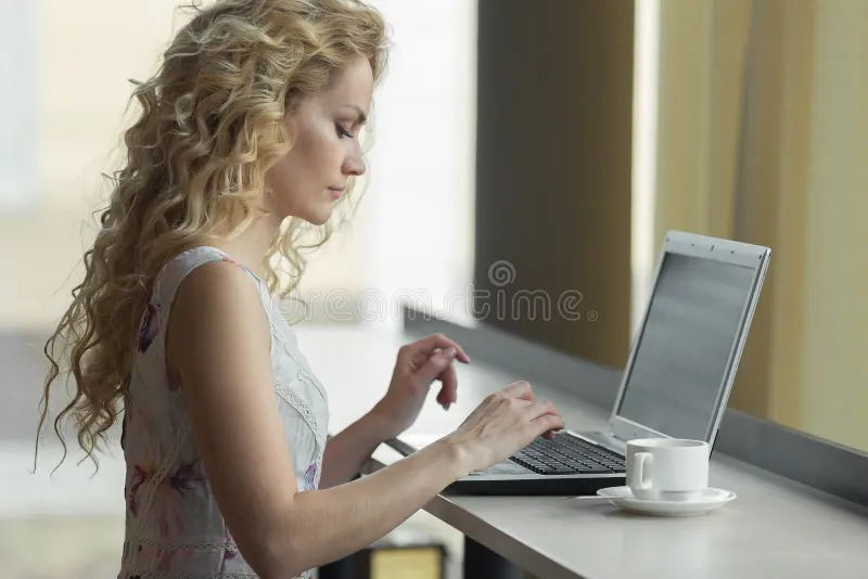 Beautiful blonde girl dress using laptop cafe blogger work concept 93749415