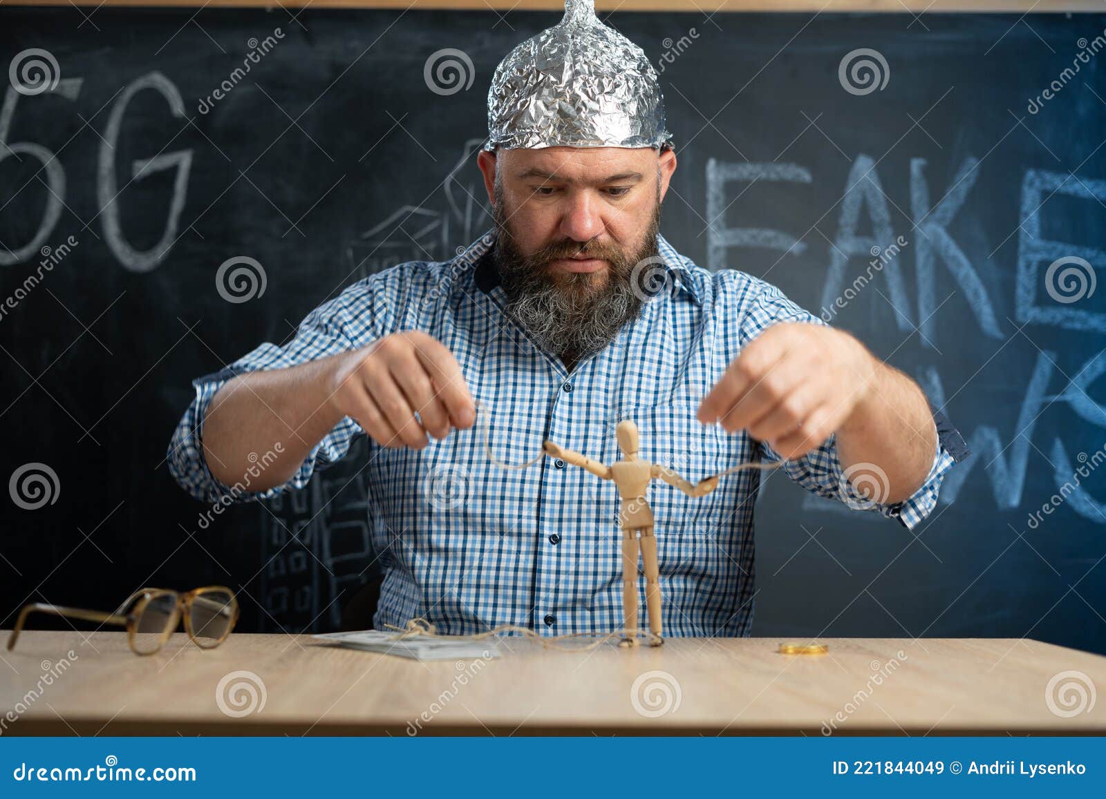 Distraught schizophrenic conspiracy theorist protective foil cap controls man toy consciousnes Distraught schizophrenic conspiracy theorist protective foil cap controls man toy consciousnes