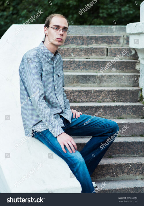 stock-photo-skinny-guy-nerdy-on-the-background-of-concrete-walls-at-sunset-405055816[1].jpg