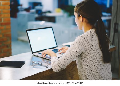 Back view female employee typing 260nw 1017576181