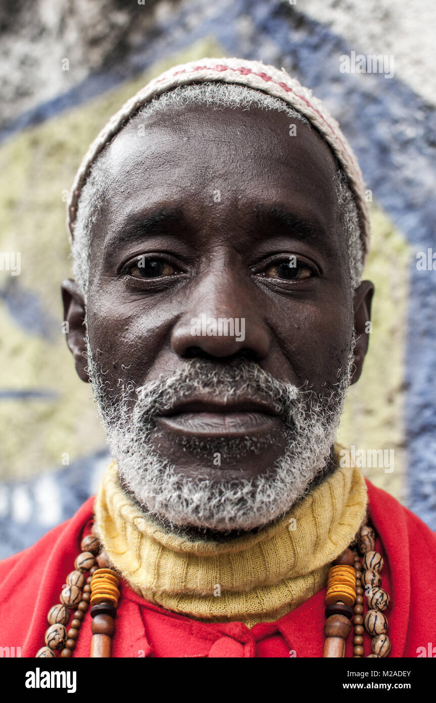 A vertical portrait of a black brazilian man with hat and beads in M2ADEY 3191996767