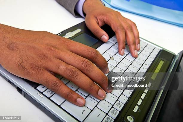 Close up of indian mans hands typing on laptop