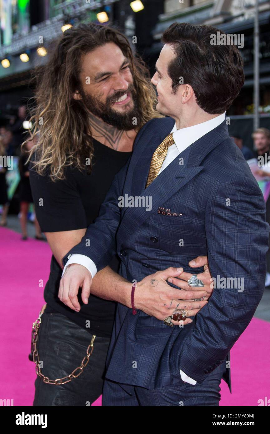 Actor jason momoa hugs henry cavill right upon arrival at the european premiere of suicide squ