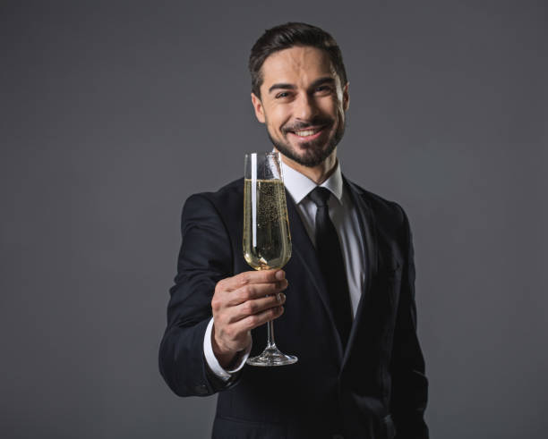 Happy smiling businessman with glass of champagne 1