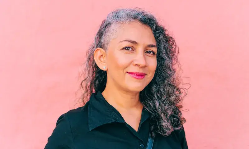 Latina-over-50-with-gray-hair (1).webp
