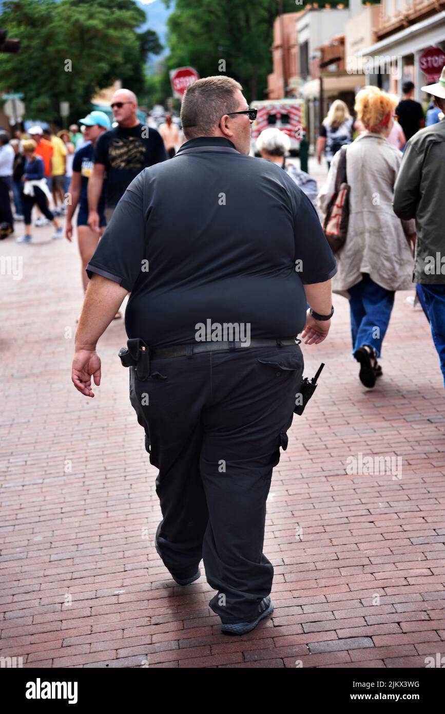 A security officer patrols the streets at an outdoor arts festival in santa fe new mexico 2JKX