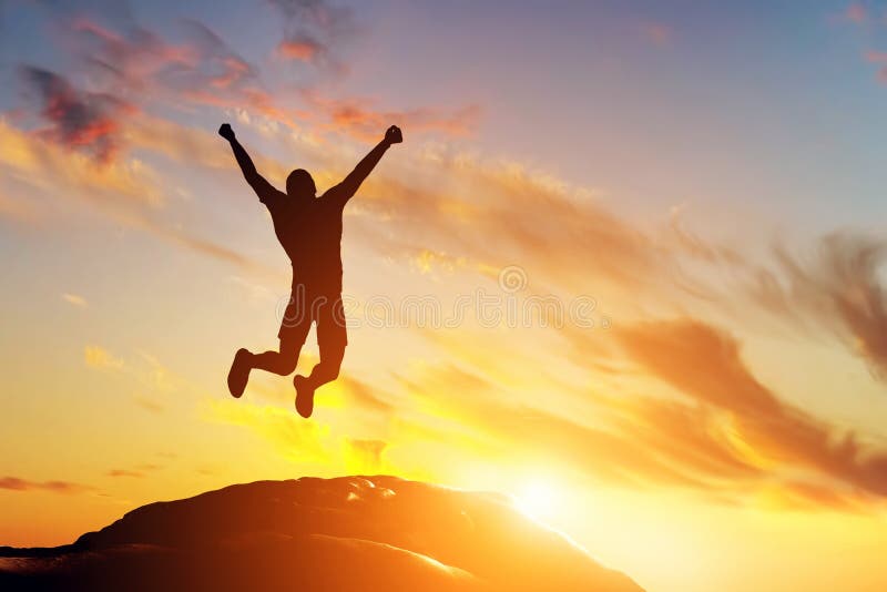 Happy man jumping joy peak mountain sunset success cliff winner happiness 42811168
