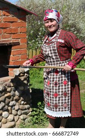 Woman finnougrian suit bakes pancakes 260nw 666872749